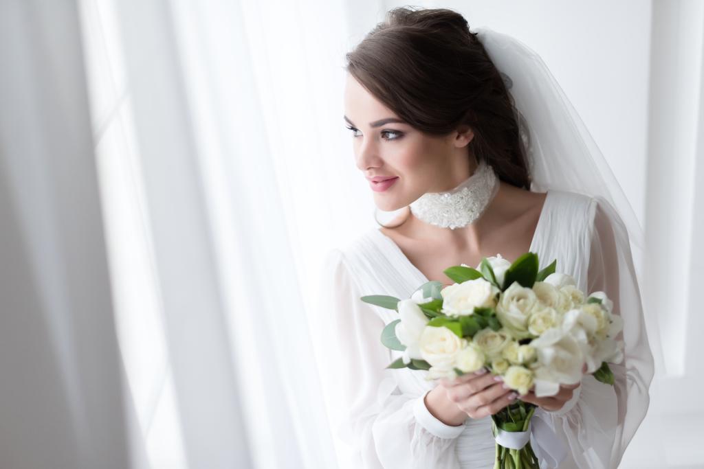 ウェディング ドレスとベールが白い花束を持って笑顔の花嫁 ロイヤリティフリー写真 画像素材