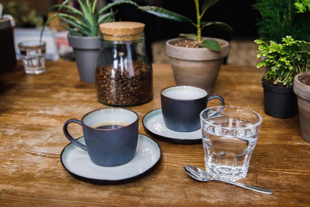 Cups Of Coffee And Glass Of Water Free Stock Photo And Image
