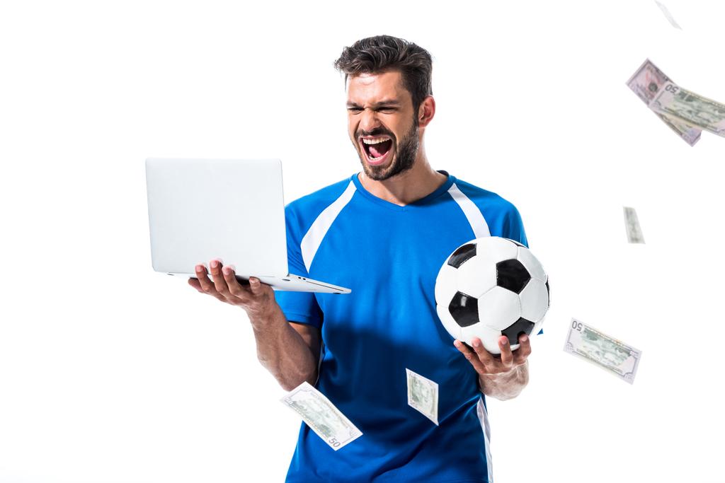 ボールとラップトップでサッカー選手を応援する お金の近くに孤立した白に孤立 ロイヤリティフリー写真 画像素材