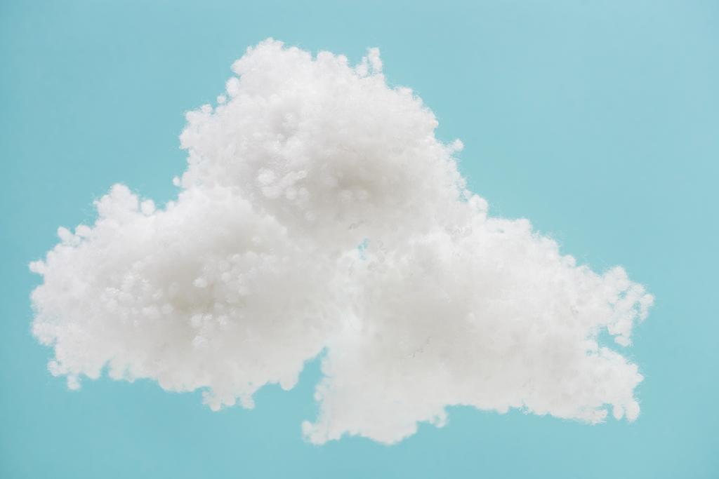 青い背景に隔離されたコットンウールで作られた白いふわふわの雲 ロイヤリティフリー写真 画像素材