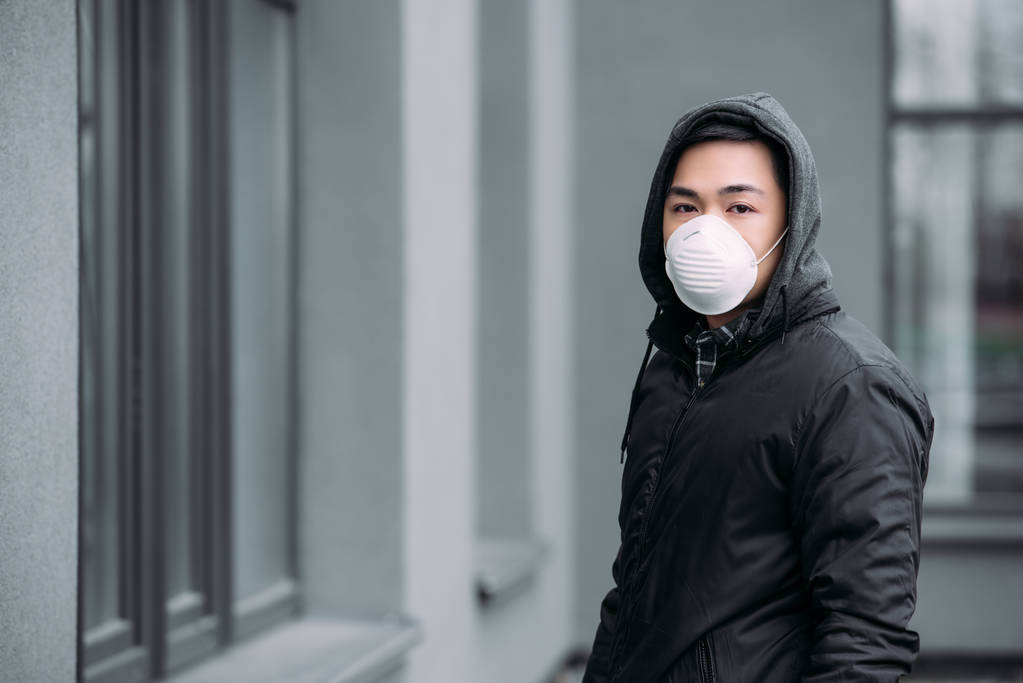 Young Asian Man In Respirator Mask Looking Free Stock Photo and Image