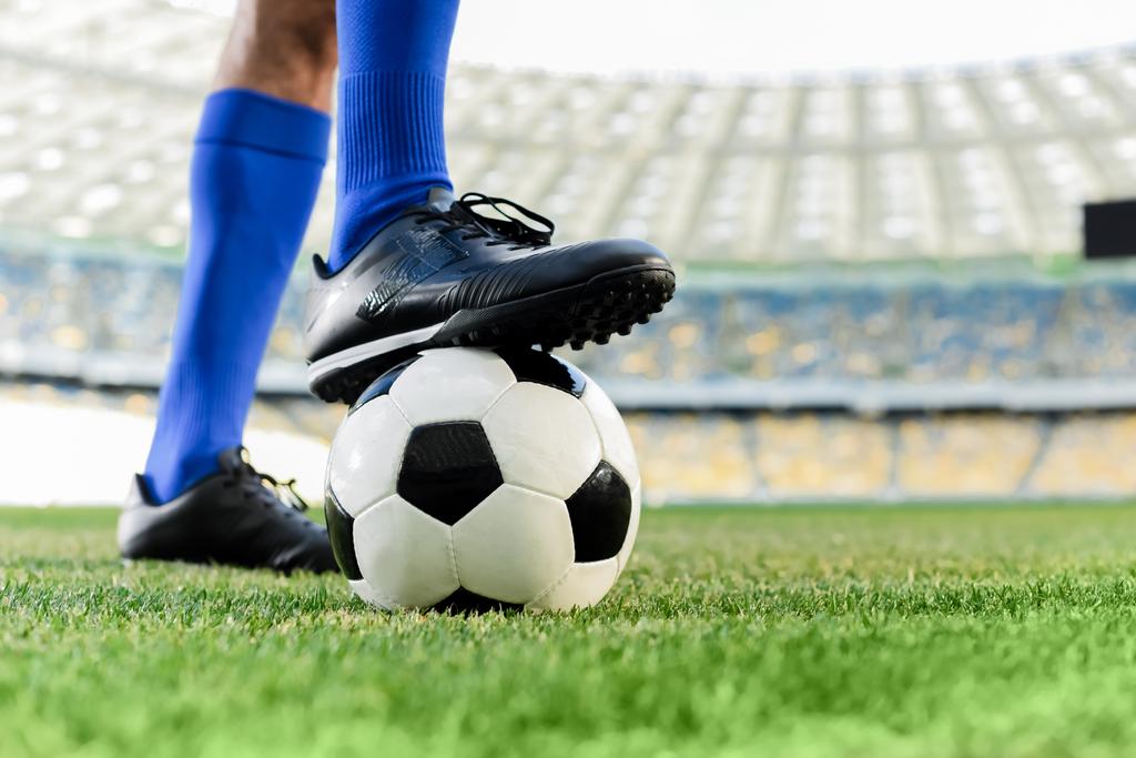 ブルーソックスのプロサッカー選手の足やスタジアムのボールのサッカーシューズ ロイヤリティフリー写真 画像素材