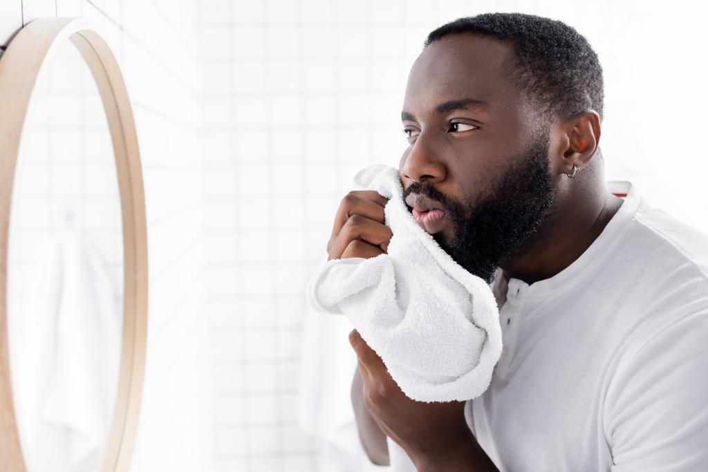 afro-american man drying beard with towel  - Photo, Image
