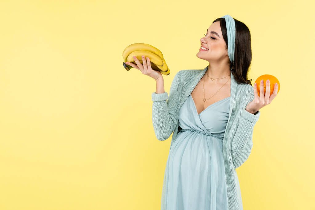 Joyful Pregnant Woman Holding Ripe Bananas Isolated Free Stock Photo and  Image