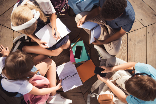 Overhead view of multiethnic teenagers studying together Free Stock Photo  and Image