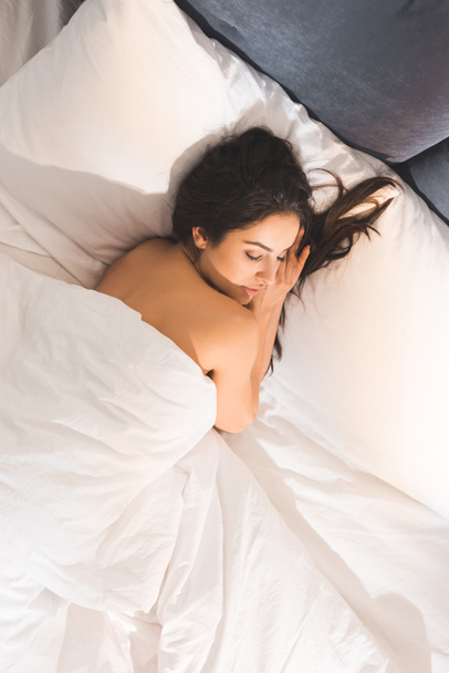 Beautiful nude woman sleeping in bed at home in morning with copy space Free Stock Photo and Image