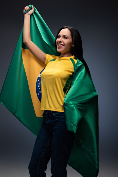 感情的な女性サッカーファンがブラジルの国旗にグレーで包まれ ロイヤリティフリー写真 画像素材