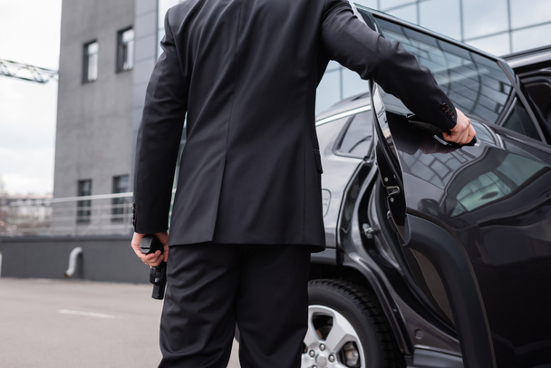 Back View Of Bodyguard In Suit Holding Free Stock Photo and Image